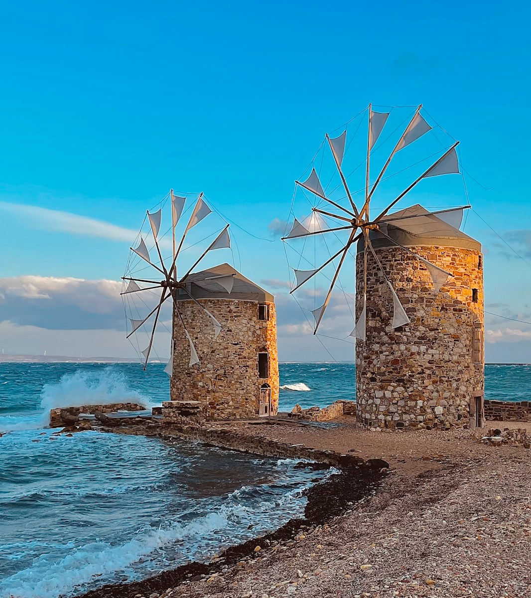 windmills on a beach with Chios in the background